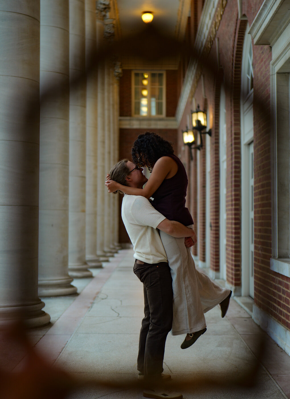 Couple lift kiss, columns corridor